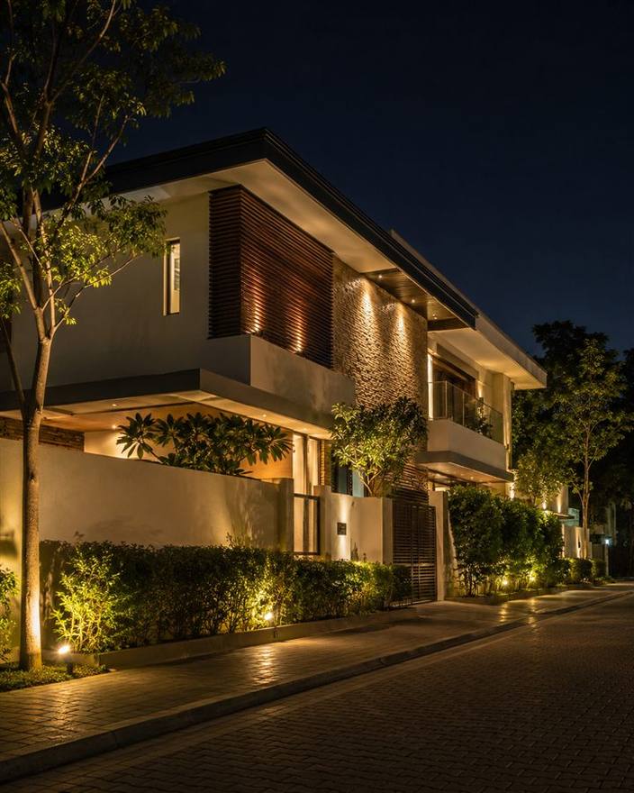 A two storey home lit up at night, a finished project